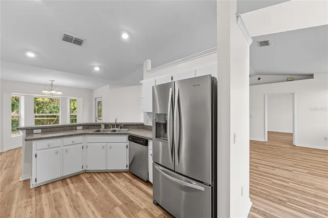 a view of a hallway with wooden floor and closet