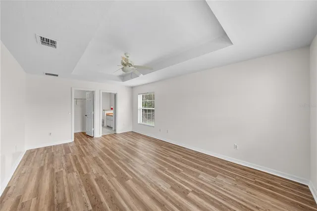 a bathroom with a tub a sink and a large mirror