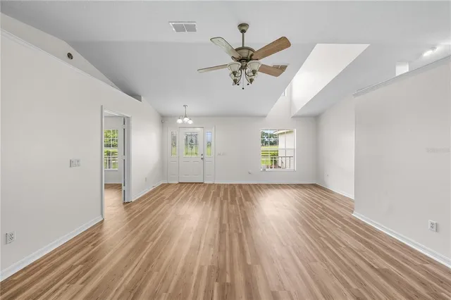 a view of a field with an trees in the background