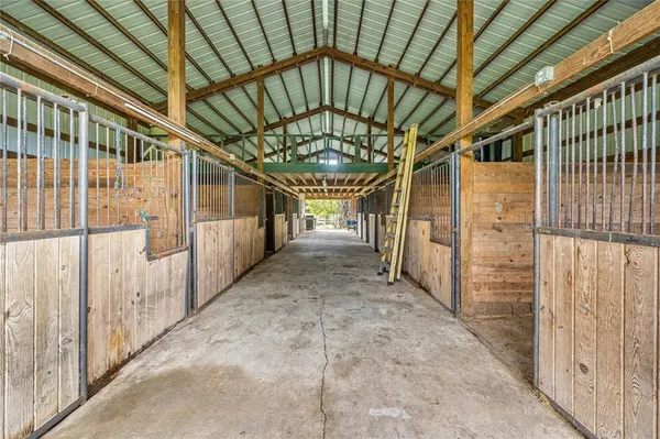 a view of a green field with wooden fence