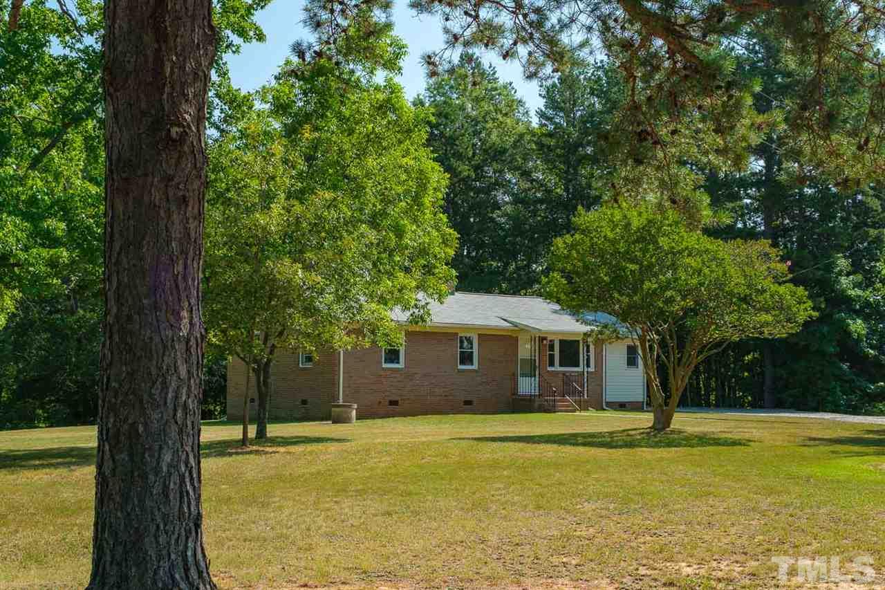1301 Royster Clay Road Roxboro, NC 27574 - Photo 1 of 30 a front view of a house with a yard