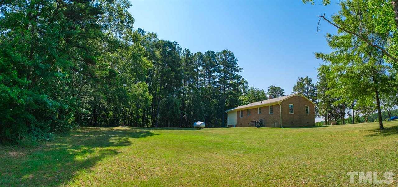 1301 Royster Clay Road Roxboro, NC 27574 - Photo 2 of 30 a house view with swimming pool in front of it
