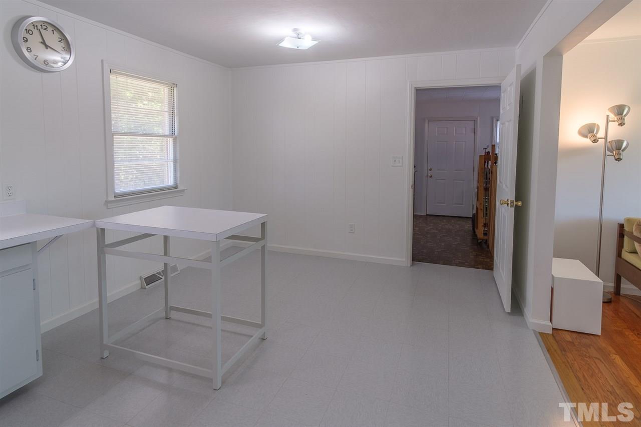 1301 Royster Clay Road Roxboro, NC 27574 - Photo 11 of 30 an empty room with a workbench
