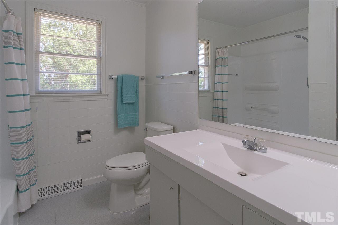 1301 Royster Clay Road Roxboro, NC 27574 - Photo 13 of 30 a bathroom with a sink toilet and shower