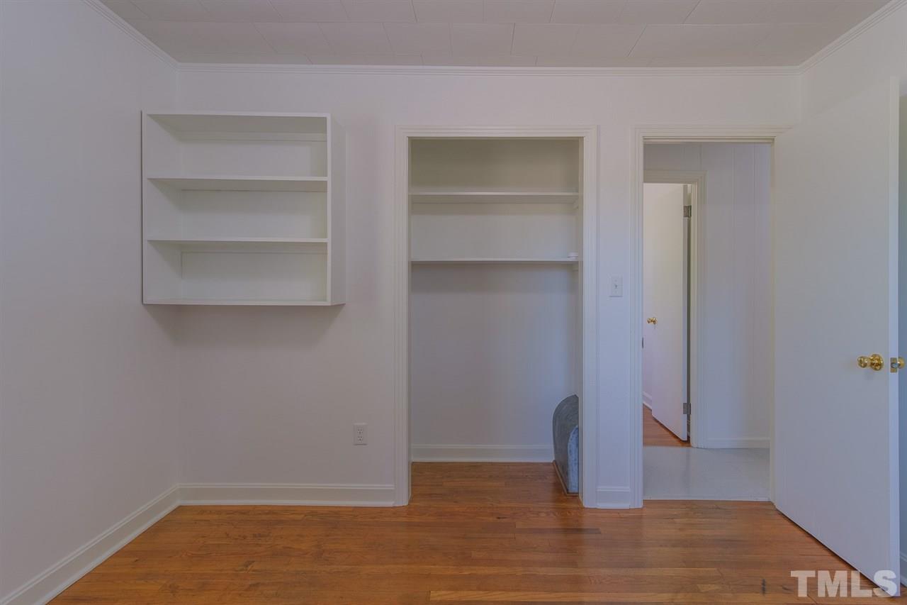 1301 Royster Clay Road Roxboro, NC 27574 - Photo 16 of 30 a view of an empty room with wooden floor and closet