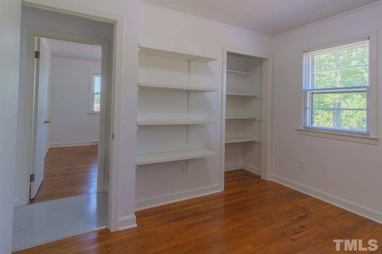 1301 Royster Clay Road Roxboro, NC 27574 - Photo 18 of 30 a room with walk in closet and wooden floor