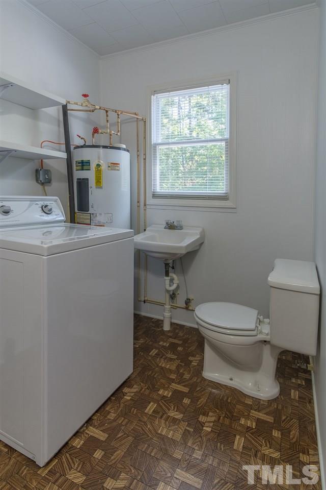 1301 Royster Clay Road Roxboro, NC 27574 - Photo 20 of 30 a bathroom with a toilet a sink and a window