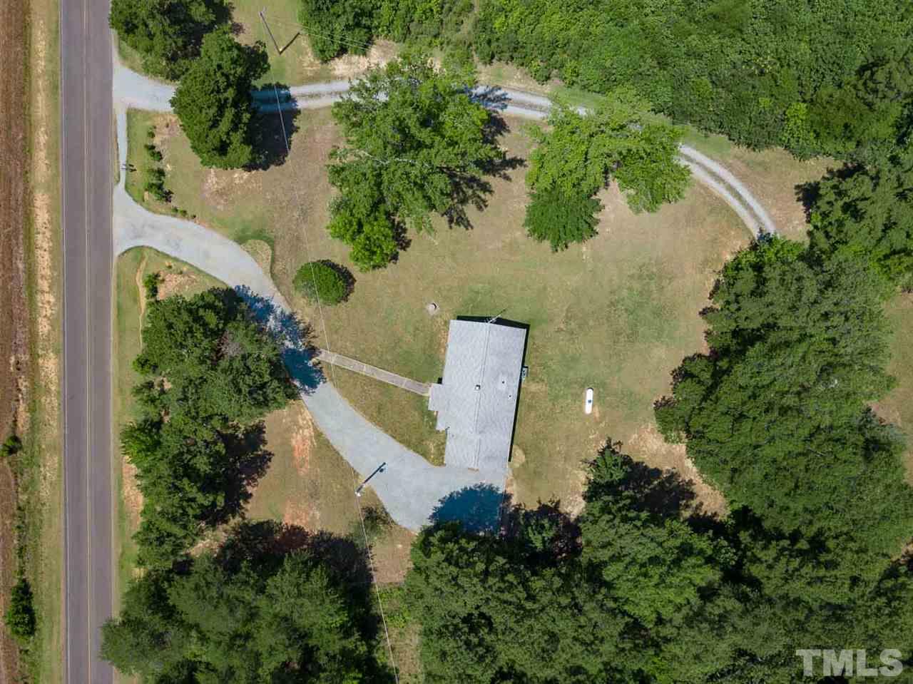 1301 Royster Clay Road Roxboro, NC 27574 - Photo 23 of 30 an aerial view of residential house with outdoor space and trees all around