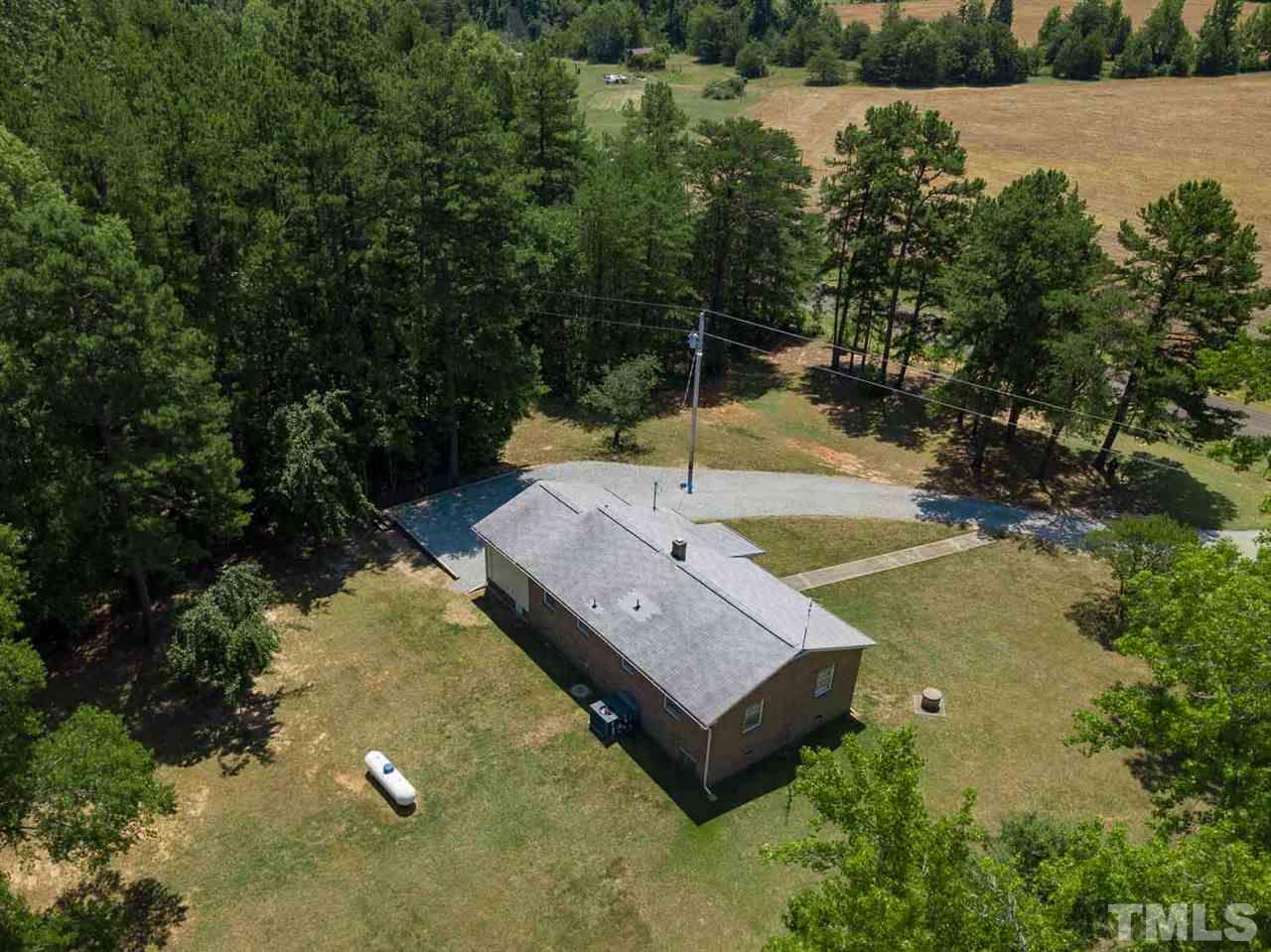 1301 Royster Clay Road Roxboro, NC 27574 - Photo 24 of 30 a view of a house with pool and a yard