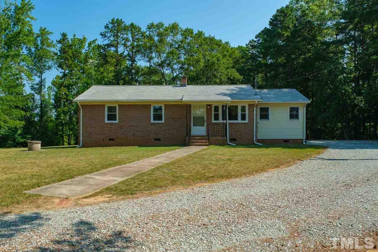 1301 Royster Clay Road Roxboro, NC 27574 - Photo 29 of 30 a front view of a house with a garden