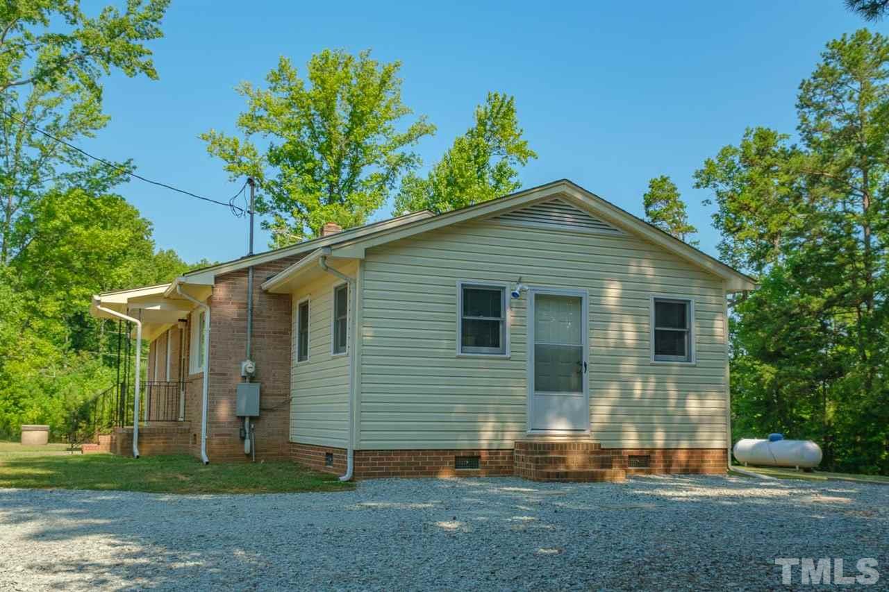1301 Royster Clay Road Roxboro, NC 27574 - Photo 4 of 30 a front view of a house with a yard
