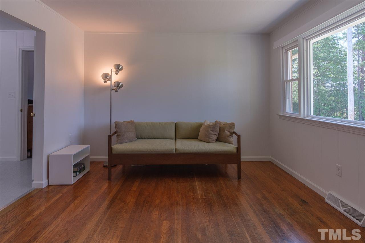1301 Royster Clay Road Roxboro, NC 27574 - Photo 6 of 30 a living room with furniture and a wooden floor