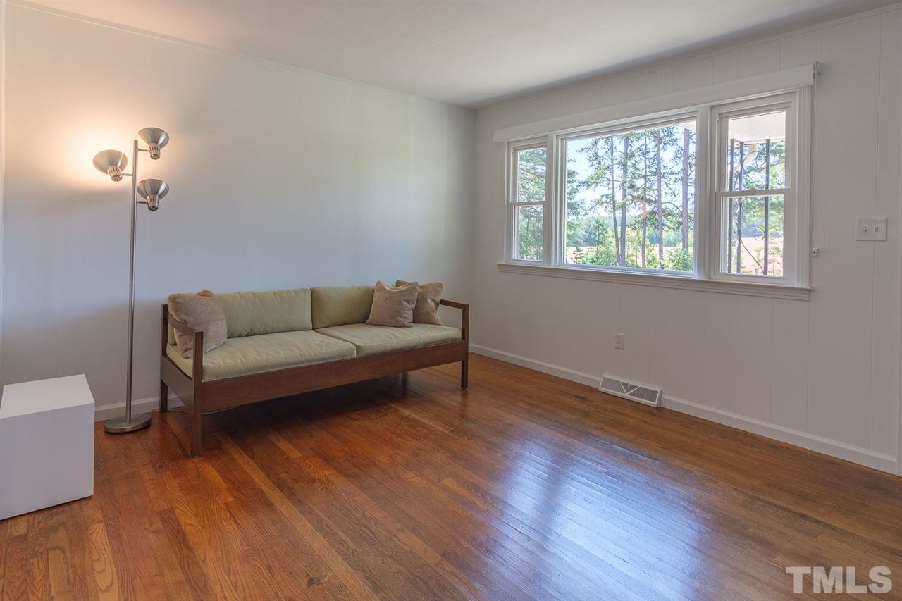 1301 Royster Clay Road Roxboro, NC 27574 - Photo 7 of 30 a living room with furniture and a wooden floor