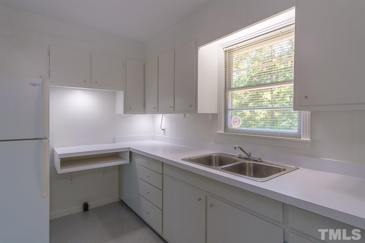 1301 Royster Clay Road Roxboro, NC 27574 - Photo 9 of 30 a kitchen with a sink cabinets and window