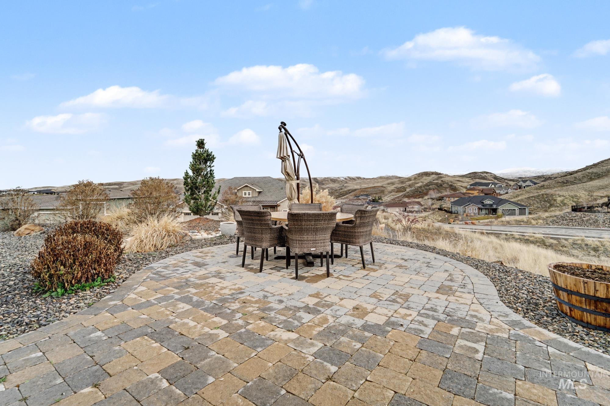 18357 North Burnt Car Way Boise, ID 83714 - Photo 33 of 48 View of patio featuring outdoor dining space and a mountain view