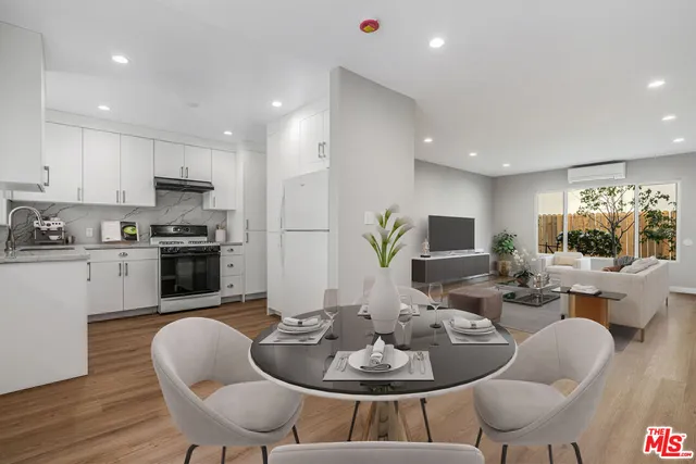 a living room with furniture kitchen and a table