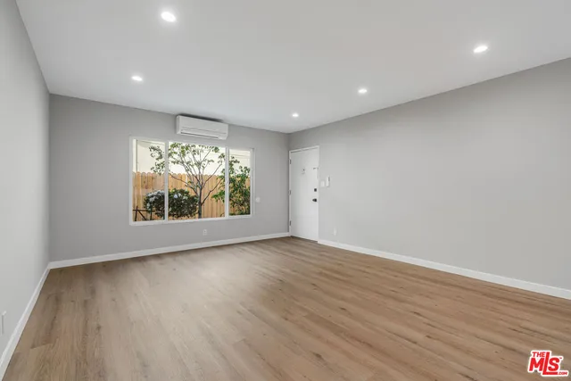 a view of room with window and wooden floor