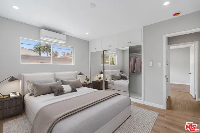 a bedroom with a bed and a painting on the wall