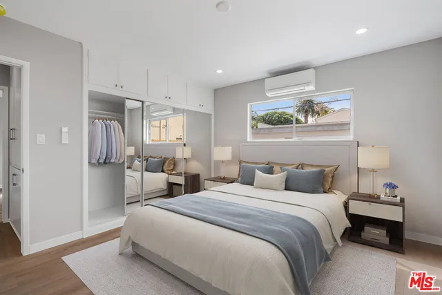 a bedroom with a bed and a painting on the wall