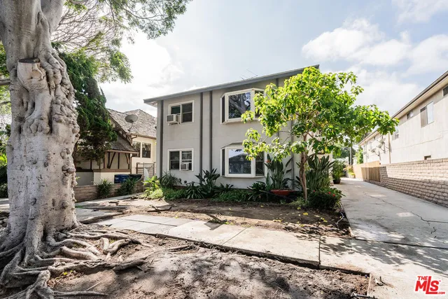 a pathway of a house with a yard