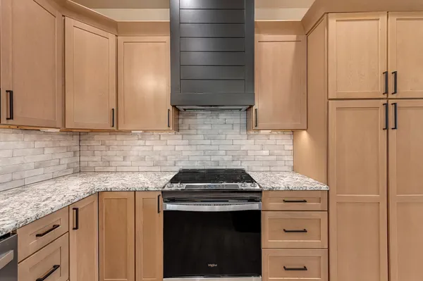 a large room with kitchen view and a stove