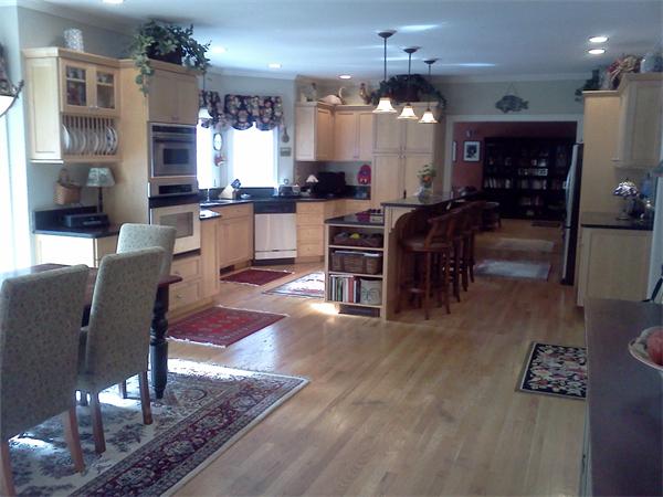 17 B Old Topsfield Road Boxford, MA 01921 - Photo 8 of 29 a kitchen with stainless steel appliances kitchen island granite countertop a refrigerator a stove top oven a dining table and chairs