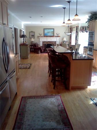 17 B Old Topsfield Road Boxford, MA 01921 - Photo 9 of 29 a kitchen with stainless steel appliances kitchen island granite countertop a refrigerator a stove a sink and a dining table