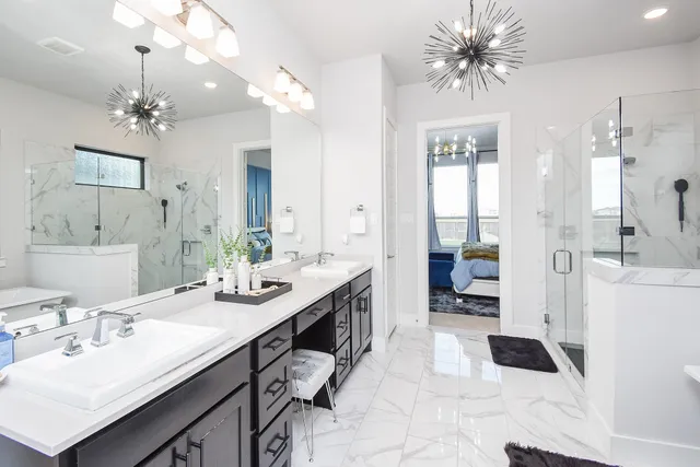 a spacious bathroom with a granite countertop sink a toilet a mirror and shower