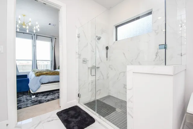 a bathroom with a tub shower and window