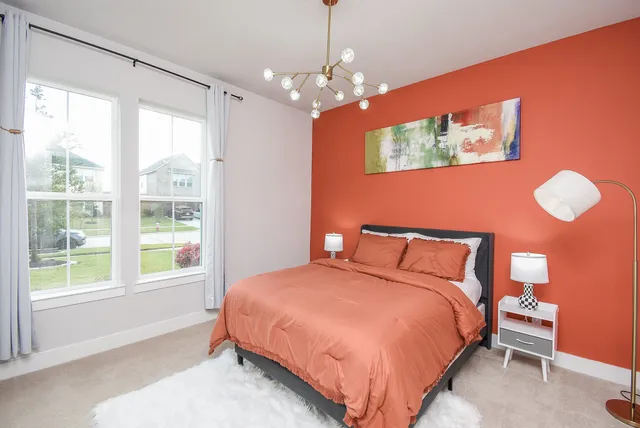 a bedroom with a large bed and a window