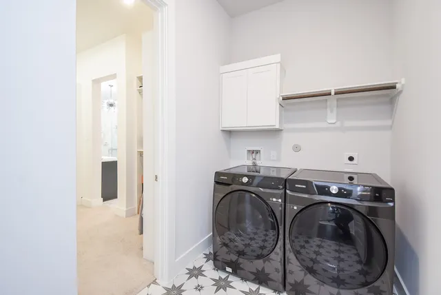 a utility room with sink dryer and washer