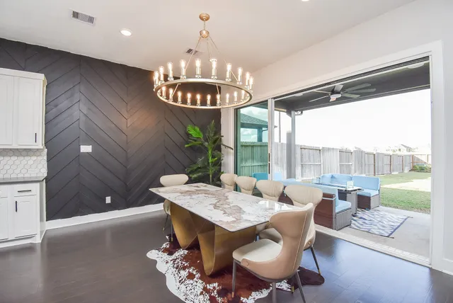a dining room with furniture a chandelier and window