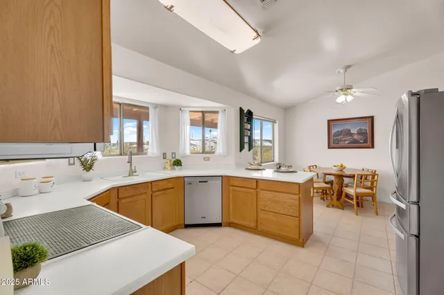 a kitchen with stainless steel appliances granite countertop a sink a stove and a microwave