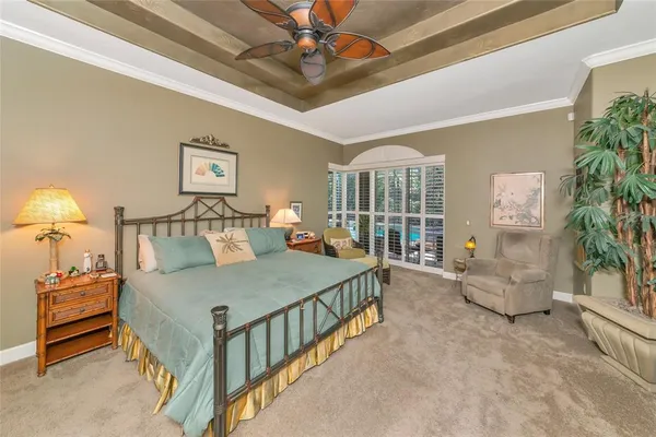 a bedroom with furniture and a large window