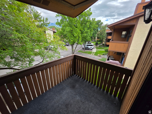 6852 Countrywoods Circle, Unit 5D Midvale, UT 84047 - Photo 11 of 50 Private balcony featuring dark slat railing and carpeted flooring