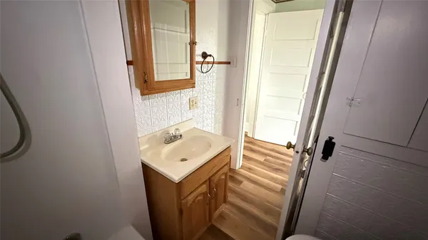 a bathroom with a sink a mirror and a shower