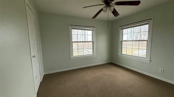 a view of room with window and ceiling fan