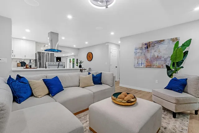 a kitchen with stainless steel appliances a sink a stove a refrigerator and cabinets