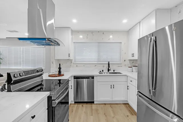 a living room with furniture a rug and a fireplace