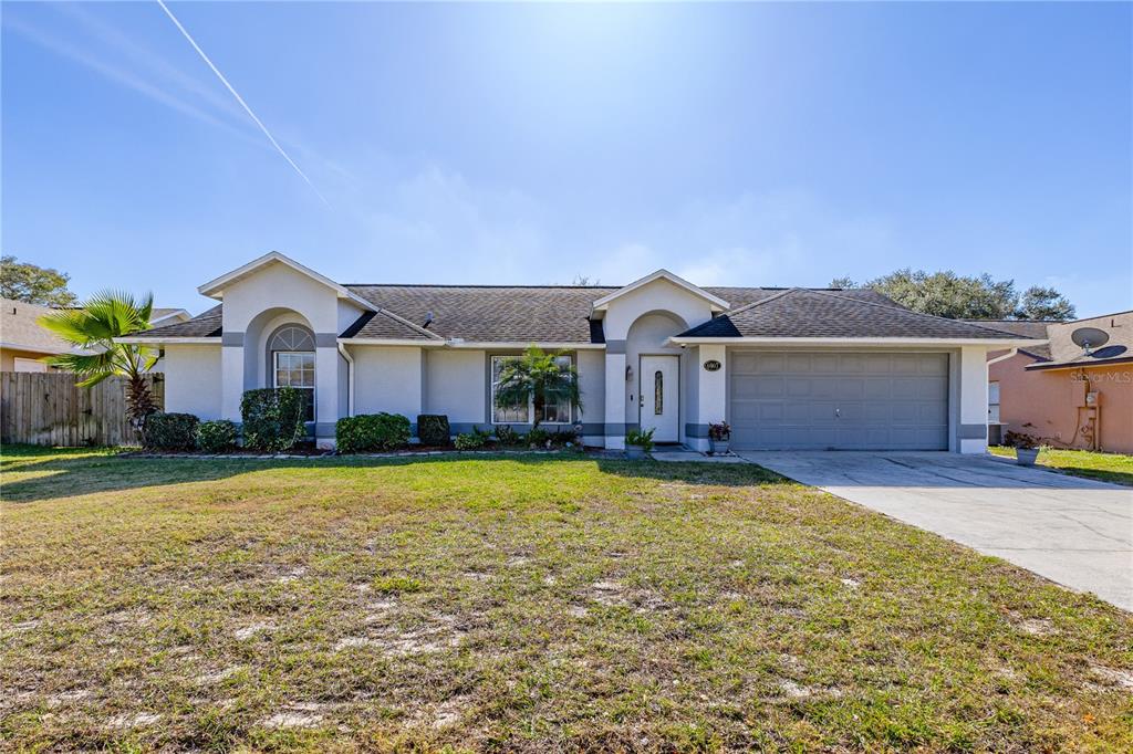 a front view of a house with yard and garage