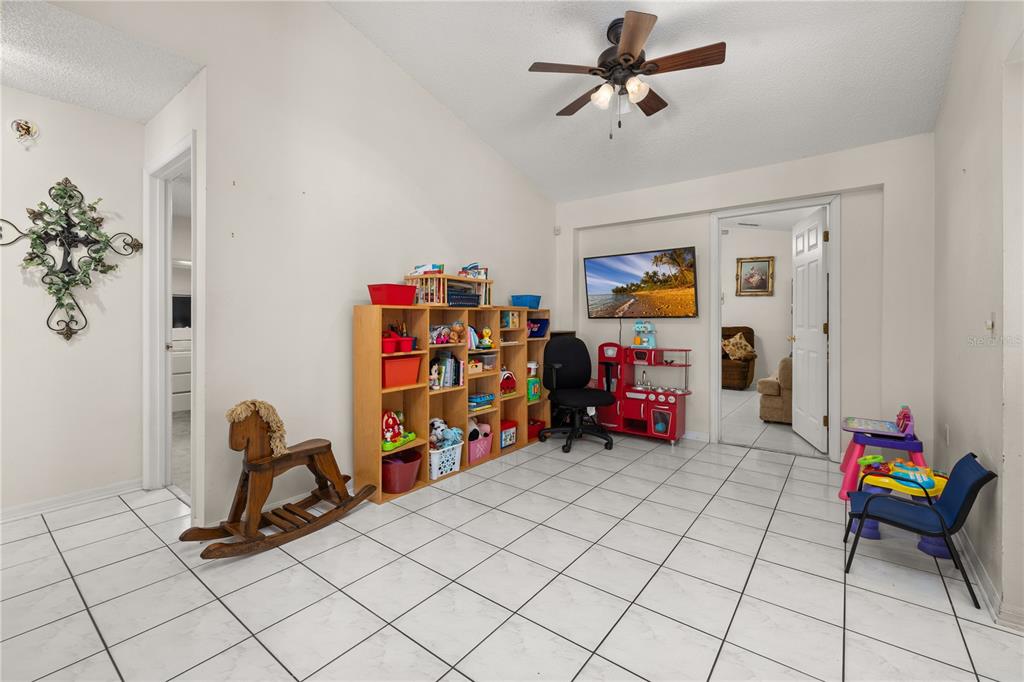 6907 Log Jam Court Ocoee, FL 34761 - Photo 12 of 30 a living room with furniture and a gym machine