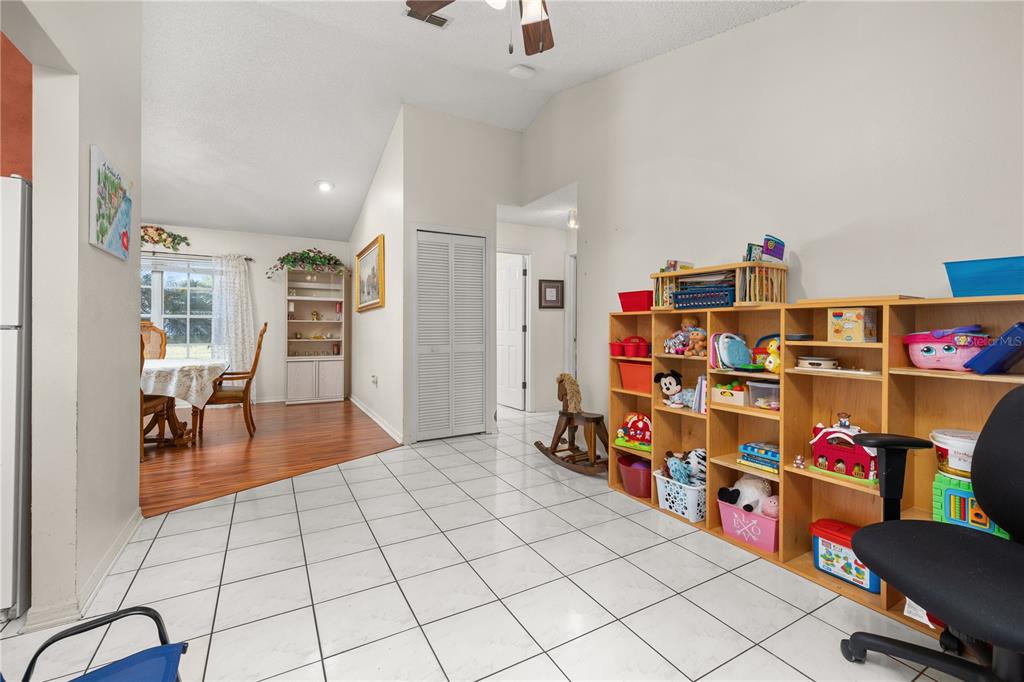 6907 Log Jam Court Ocoee, FL 34761 - Photo 13 of 30 a book shelf with books and a dining table