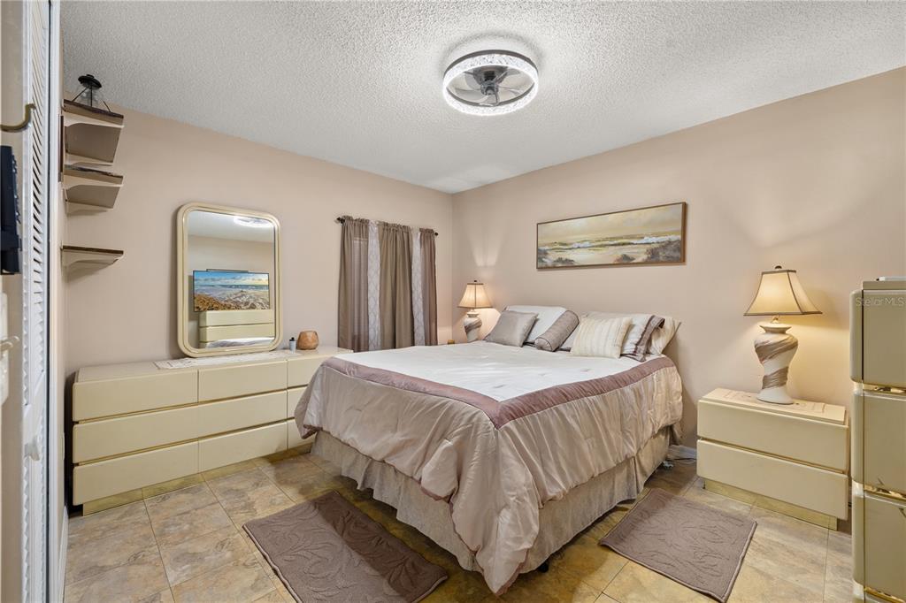 6907 Log Jam Court Ocoee, FL 34761 - Photo 14 of 30 a bedroom with a bed and a chandelier