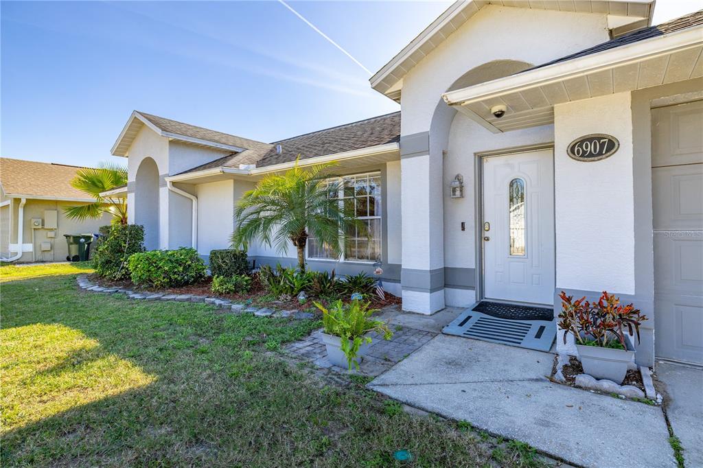 6907 Log Jam Court Ocoee, FL 34761 - Photo 2 of 30 a front view of a house with garden