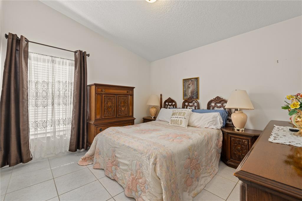 6907 Log Jam Court Ocoee, FL 34761 - Photo 21 of 30 a bedroom with a bed and a window