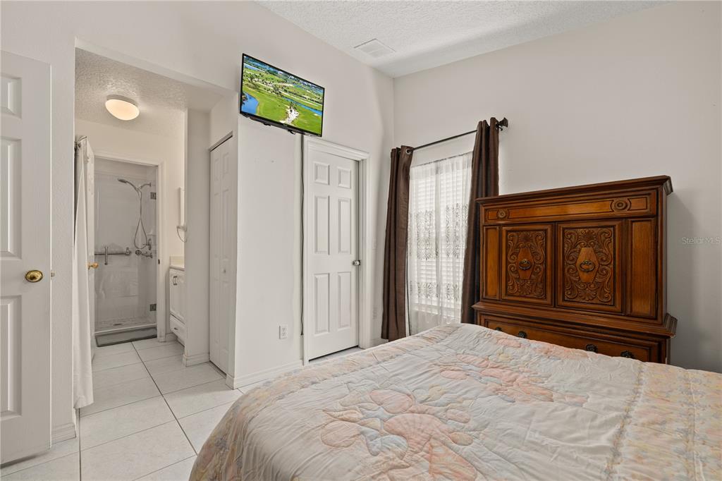 6907 Log Jam Court Ocoee, FL 34761 - Photo 22 of 30 a bedroom with a bed and a dresser