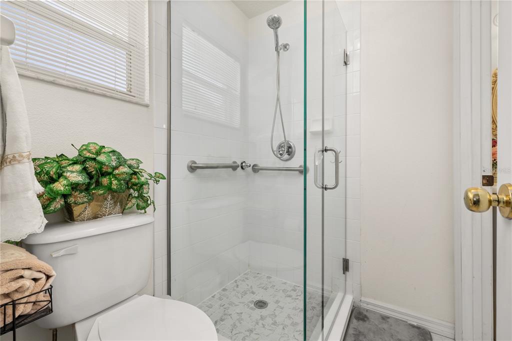 6907 Log Jam Court Ocoee, FL 34761 - Photo 25 of 30 a bathroom with a shower and a toilet