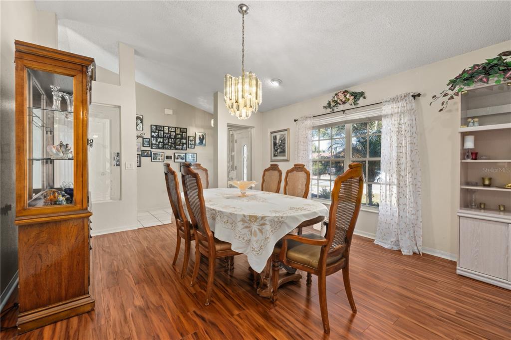 6907 Log Jam Court Ocoee, FL 34761 - Photo 4 of 30 a view of a dining room with furniture window and wooden floor