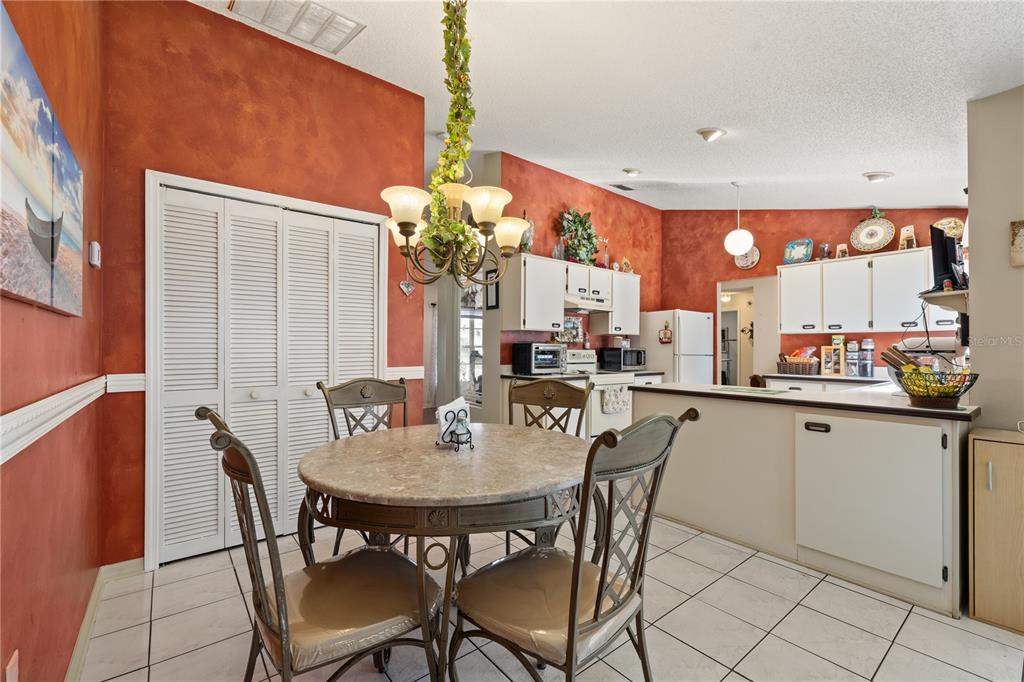 6907 Log Jam Court Ocoee, FL 34761 - Photo 6 of 30 a kitchen with a table and chairs in it