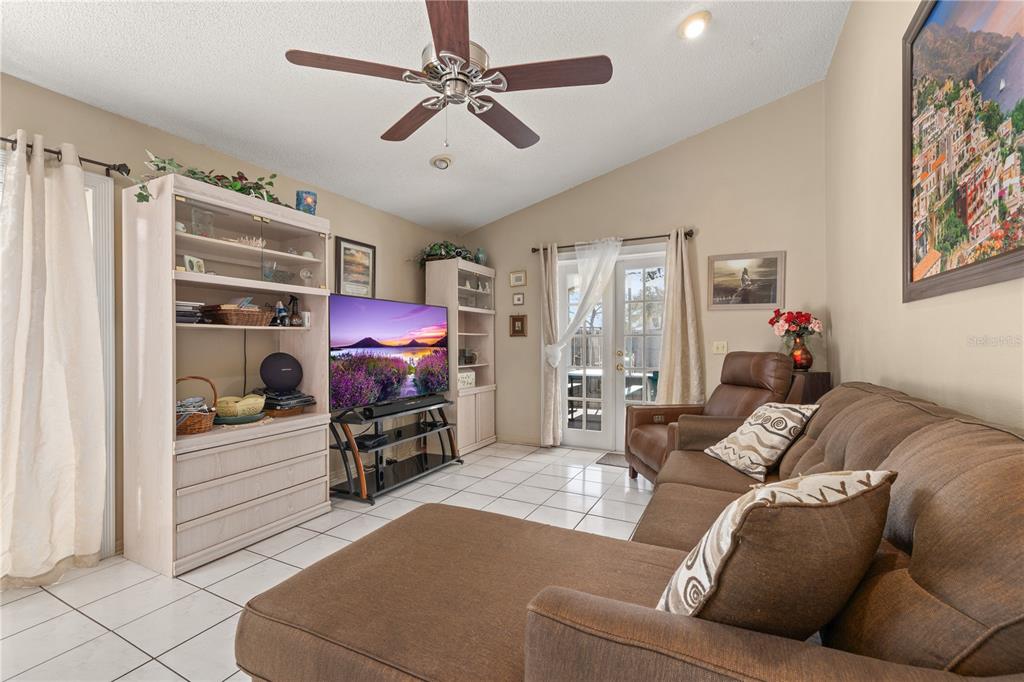 6907 Log Jam Court Ocoee, FL 34761 - Photo 8 of 30 a living room with furniture and a flat screen tv